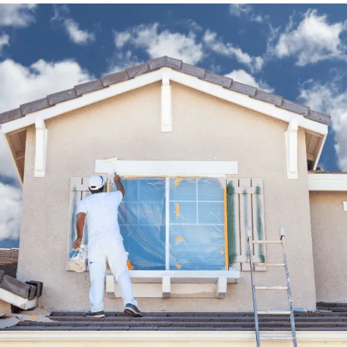 Professional painter applying a fresh exterior coat